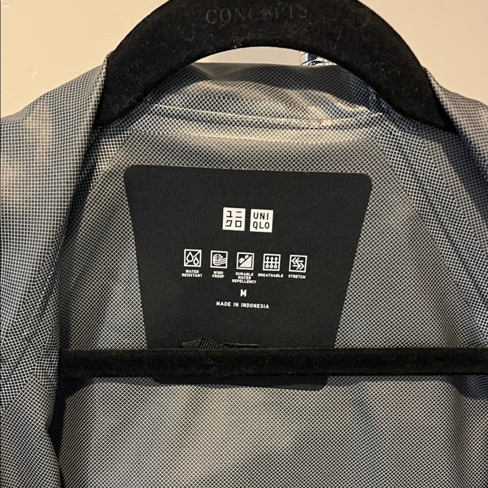 Woman’s black raincoat